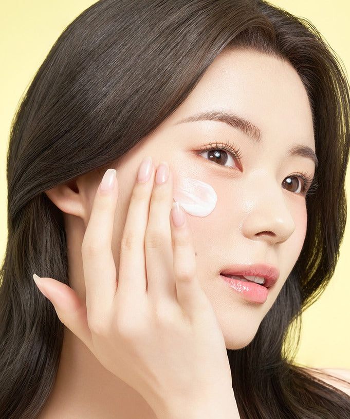Woman applying EDIT.B Moisturizing Soothing Mugwort Ceramide Cream 100ml on face.