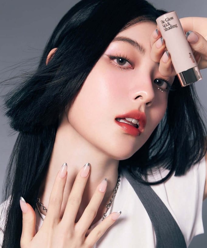 Woman posing with ESPOIR BE GLOW STICK SHADING highlighting and contouring product.