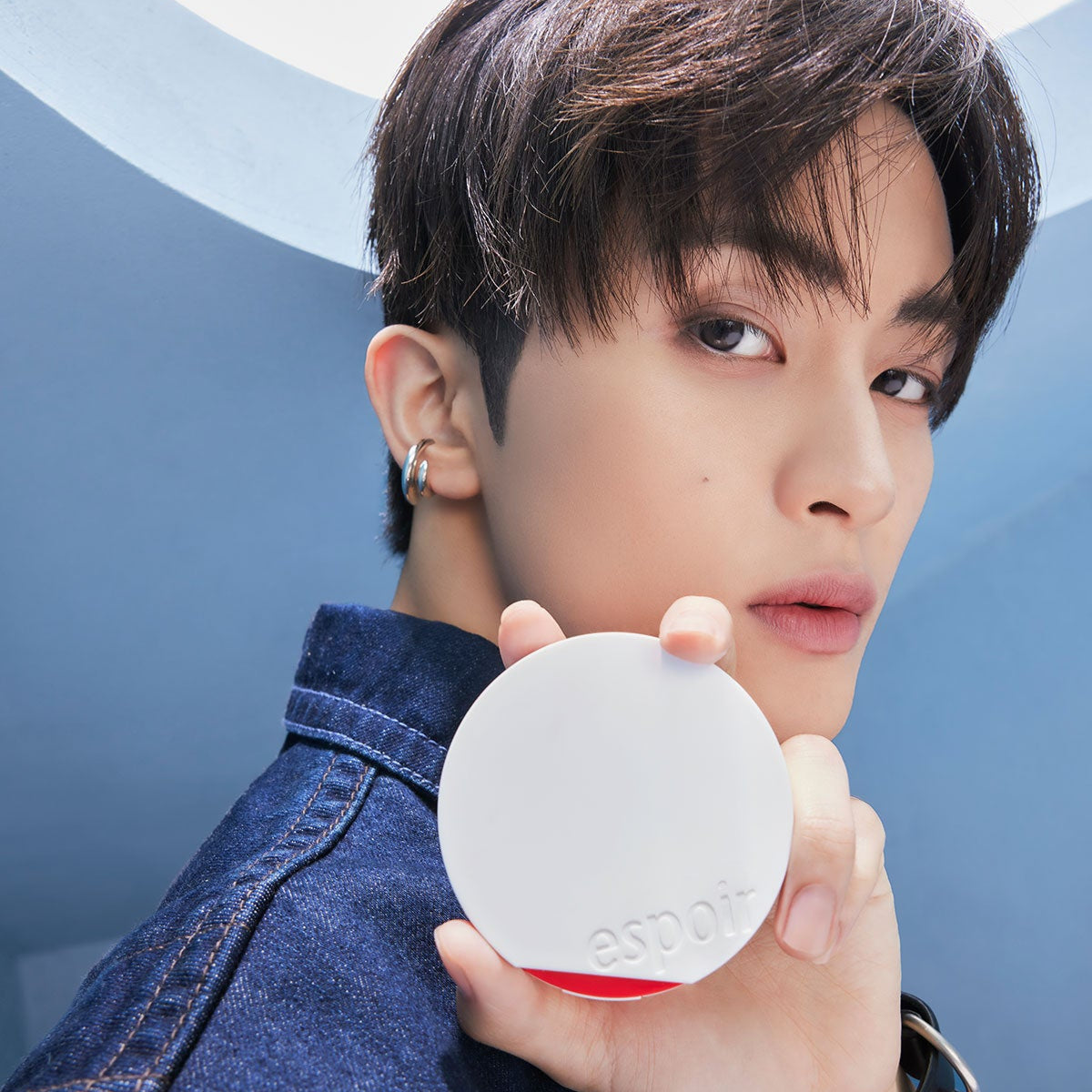 Model holding ESPOIR Bevelvet Sebumcut Cooling Cushion in sleek compact design, showcasing skincare product benefits.