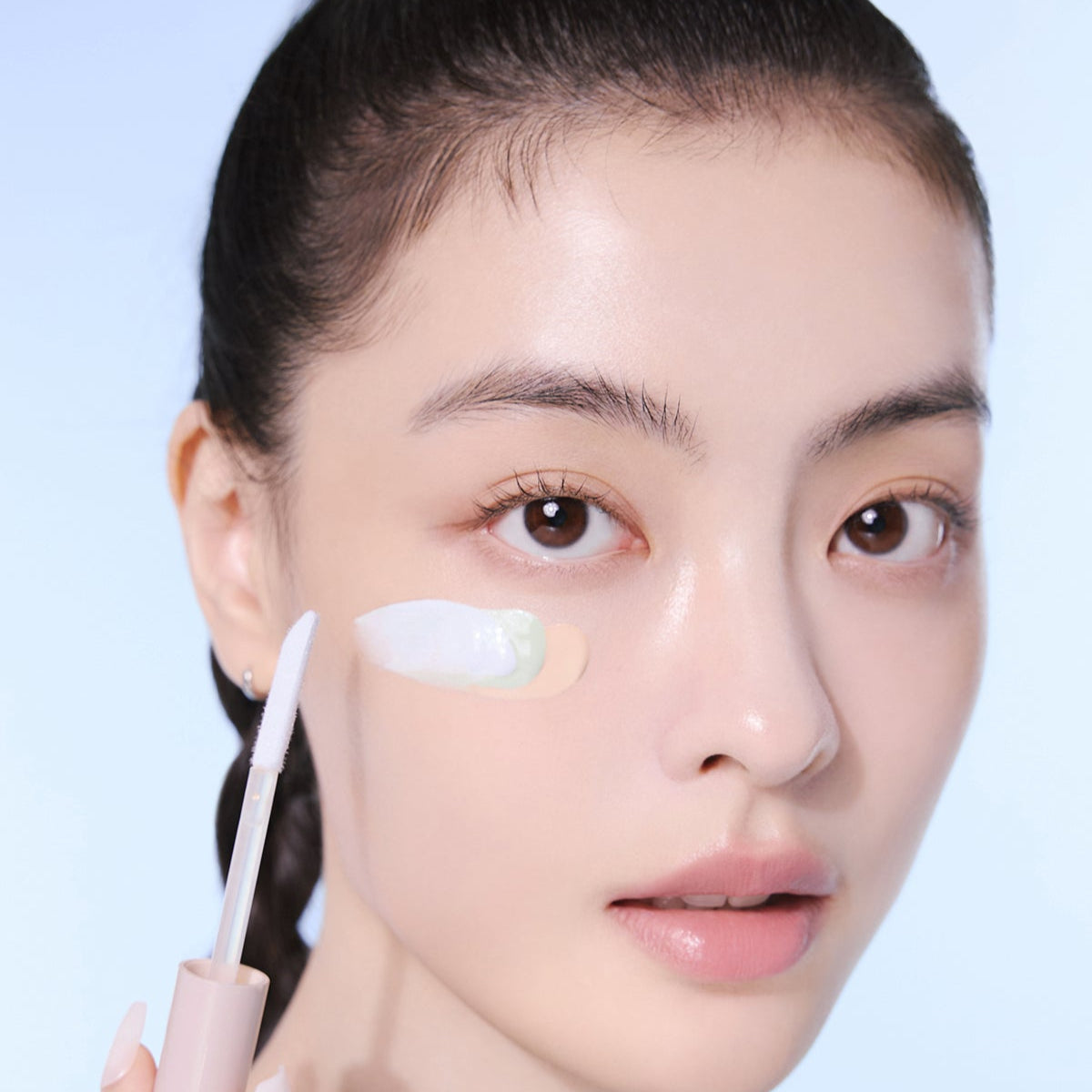 Person applying ESPOIR EASY BLENDING CONCEALER to skin with applicator brush.