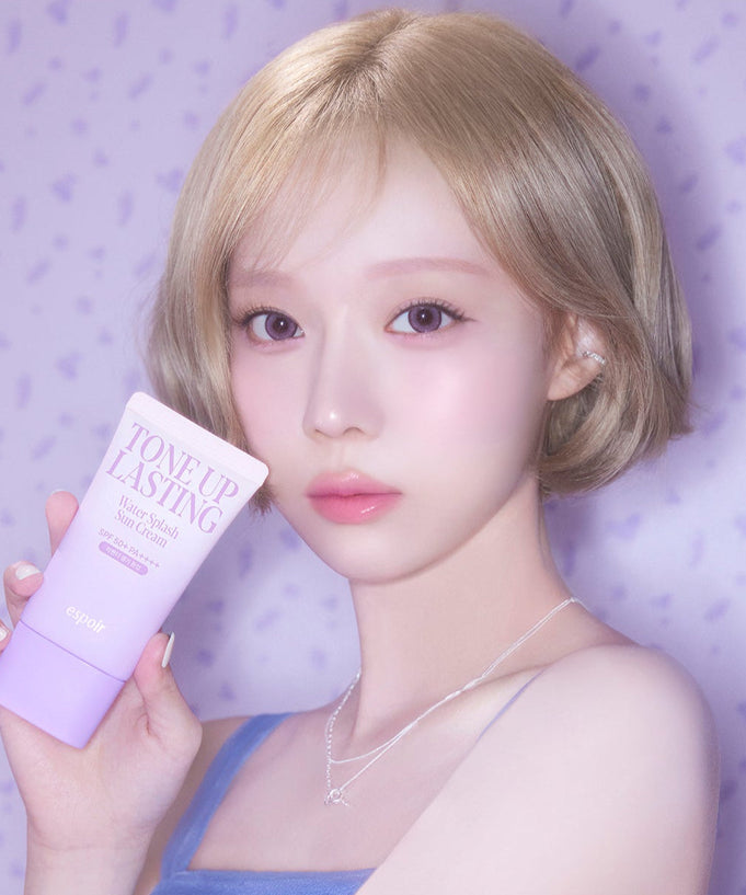 ESPOIR Water Splash Sun Cream Tone Up Lasting SPF 50+ PA++++ held by a model with purple background
