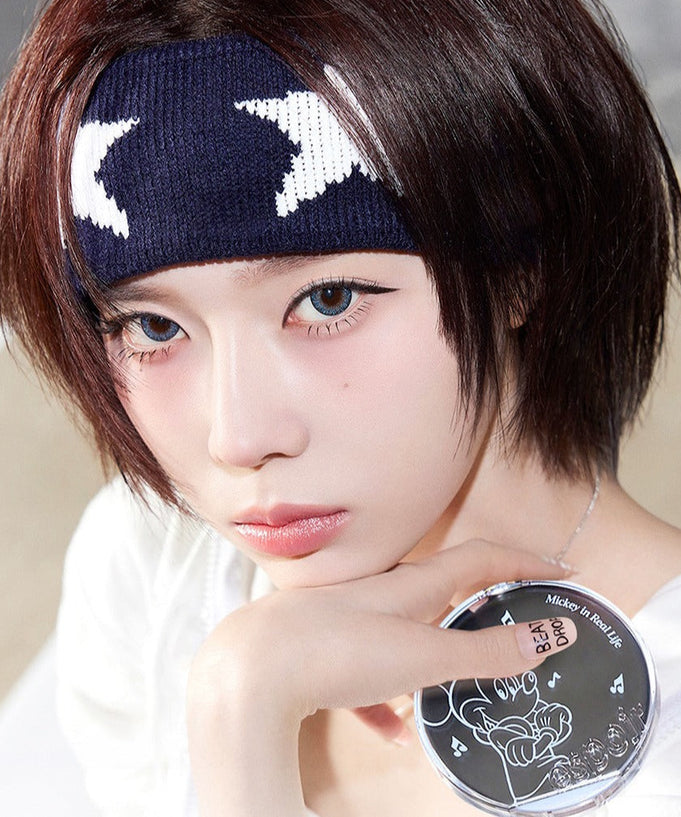 Person holding ESPOIR Bevelvet Cover Cushion SPF42/PA++ [Disney Edition] with star-themed headband.