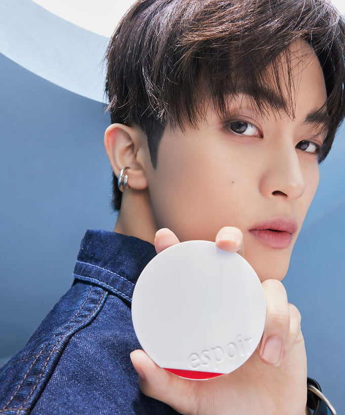 Model holding ESPOIR Bevelvet Sebumcut Cooling Cushion in sleek compact design, showcasing skincare product benefits.