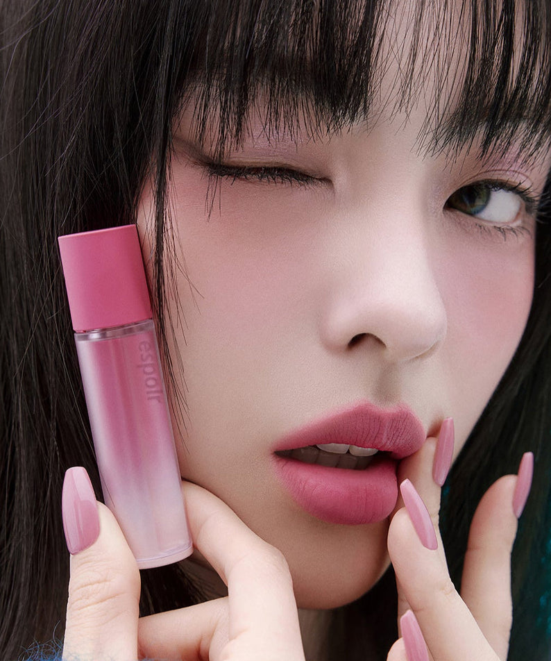 Woman with ESPOIR Couture Lip Tint Fitting Blur in pink shade applying lip tint