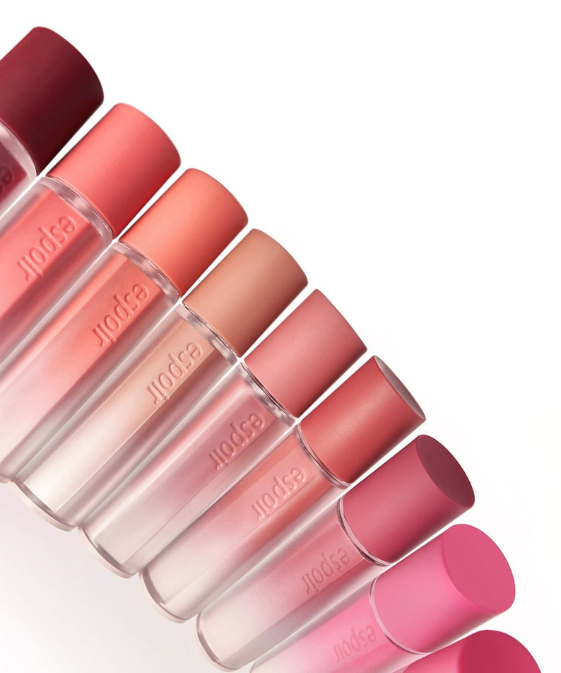 Colorful bottles of ESPOIR Couture Lip Tint Fitting Blur in various shades displayed in a diagonal arrangement.