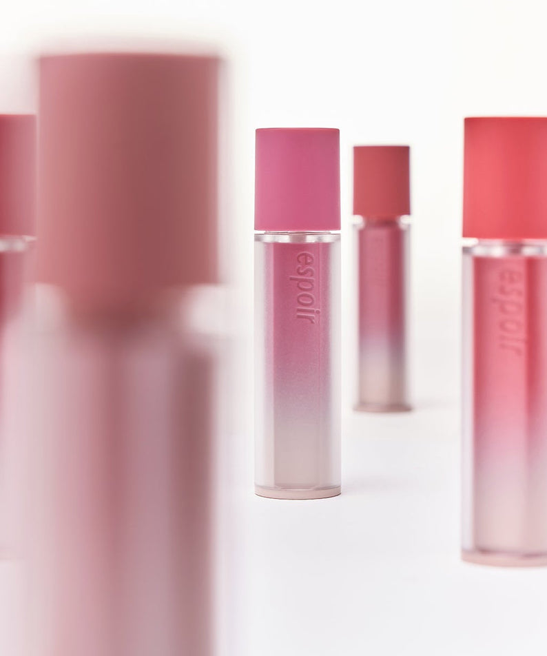 ESPOIR Couture Lip Tint Fitting Blur tubes displayed in soft focus with various shades on a white background