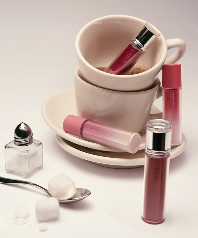 ESPOIR Couture Lip Tint Glaze [NEW COLOR] displayed with elegant cups and sugar cubes in a stylish setup