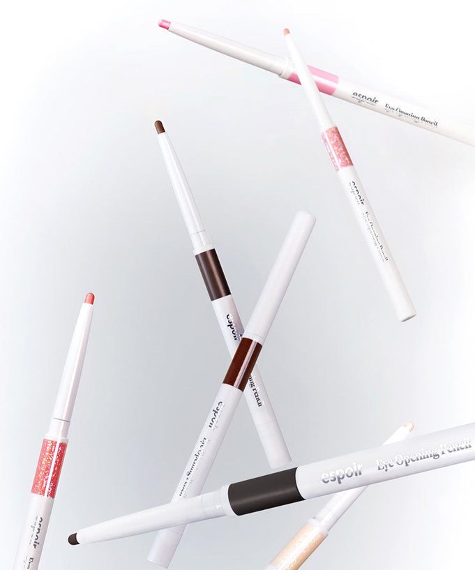 Various shades of ESPOIR Eye opening pencil floating in a stylish arrangement, showcasing their colors and sleek design.