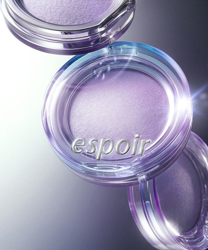 ESPOIR Strobing Highlighter [Galaxy Beam Collection] in a glowing purple shade, enhancing makeup with a radiant finish.