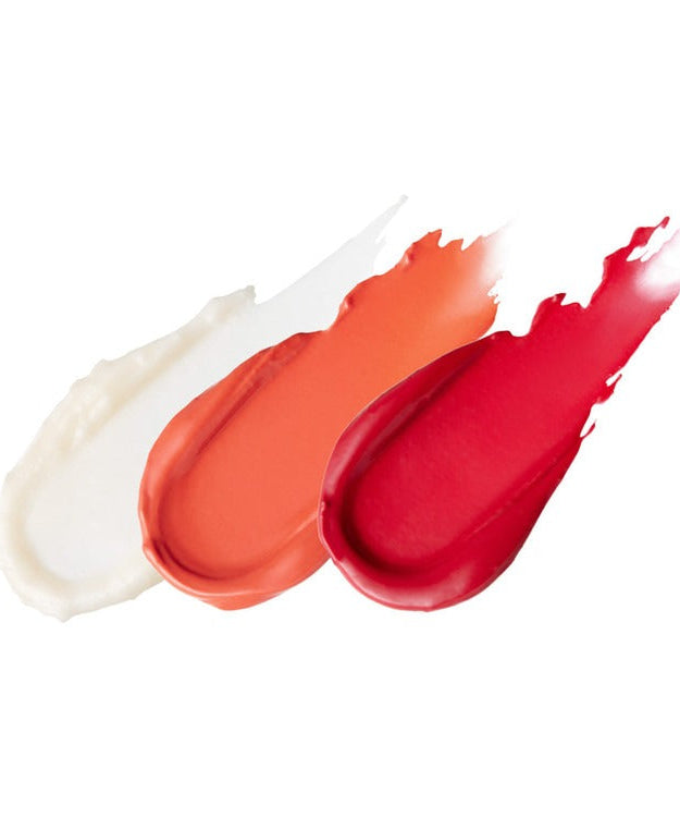 Three swatches of ESSENHERB Jojoba Essentail Lip Balm 4g in white, orange, and red shades.