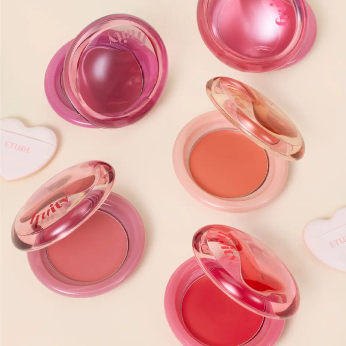 Assorted shades of ETUDE Fruity Lip & Cheek Blur Balm 2.3g open on a light background.