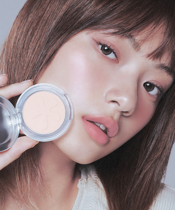 Woman applying ETUDE Face Brightener for glowing skin