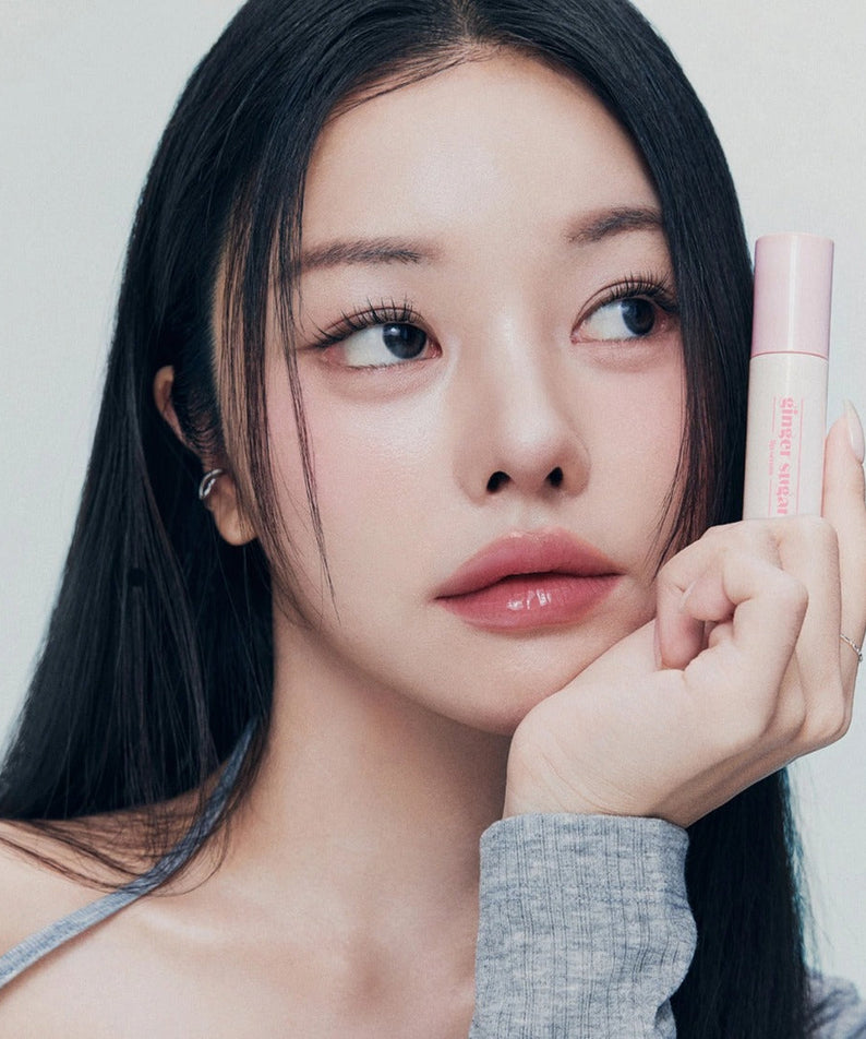 Woman holding ETUDE Ginger Sugar Lip Serum 13g, showcasing the lip care product in hand.