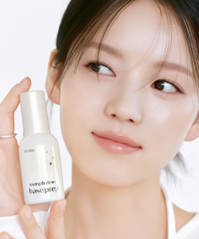 Woman holding ETUDE Nymph Dewy Base Prep 30ml