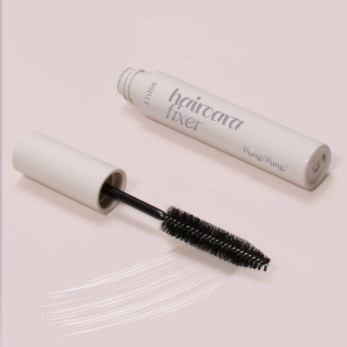 ETUDE Pangpang Hair Cara Fixer 10ml on a light background with an open brush applicator and product strokes.