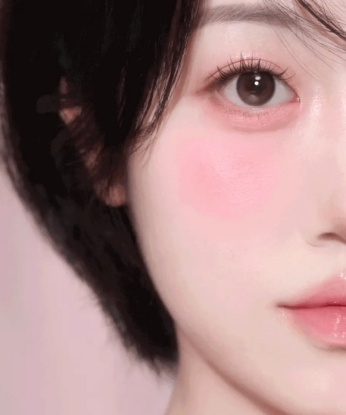 Close-up of a woman's face showcasing blush and makeup, highlighting the ETUDE Play Multi Eyes product effect.