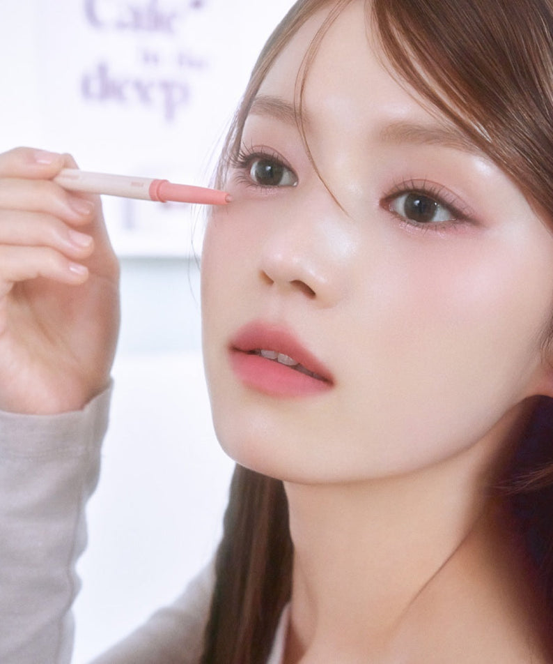 Woman applying ETUDE Re-creation Maker Aegyo-sal Liner under eyes for a youthful look.