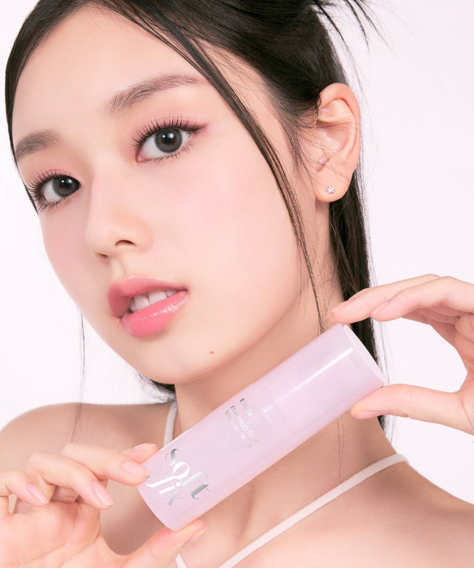 Woman holding ETUDE Soft Fix Makeup Fixer 50ml bottle with flawless complexion