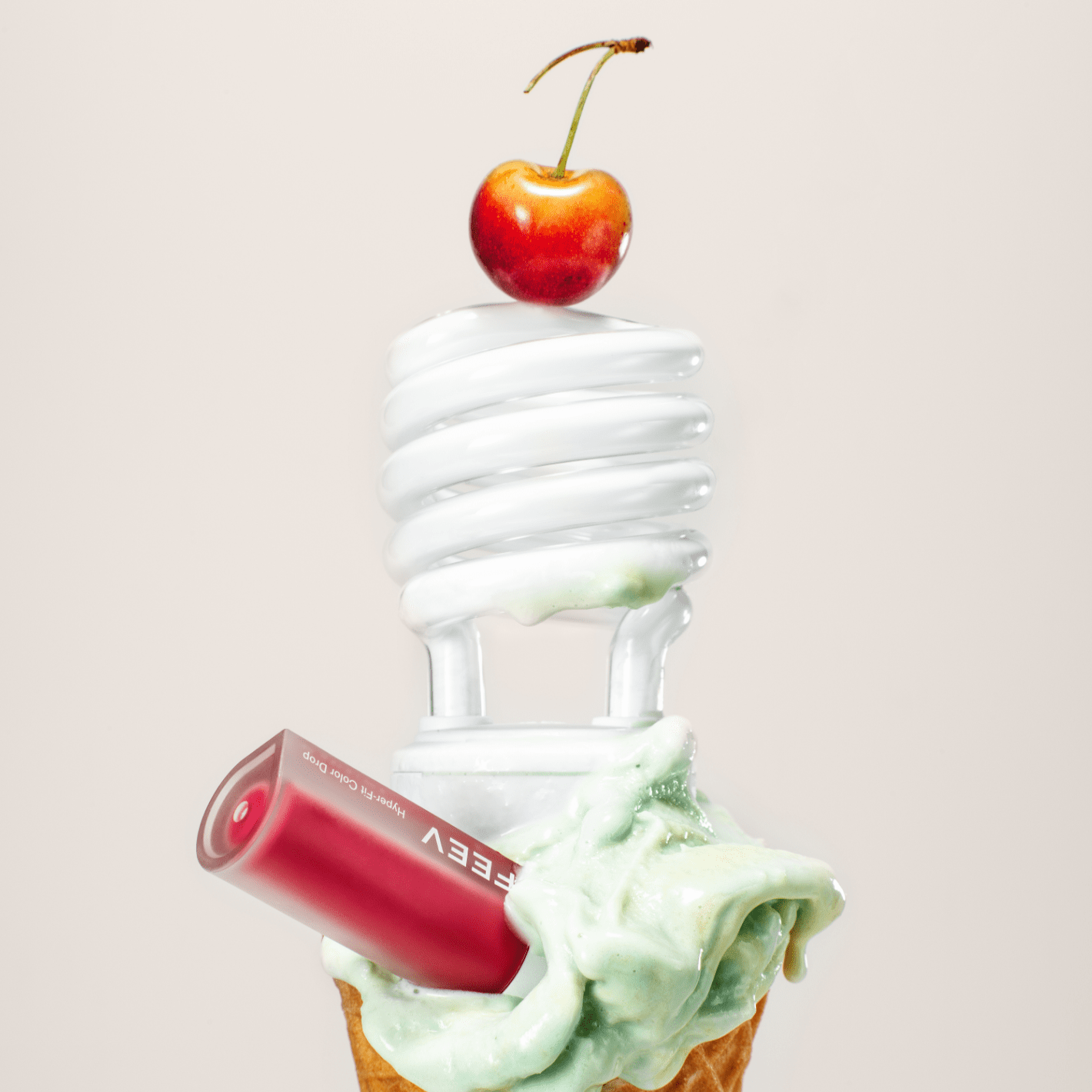 FEEV Hyper-Fit Color Drop Tint with light bulb and cone, featuring vibrant cherry on top, ideal for radiant makeup looks.
