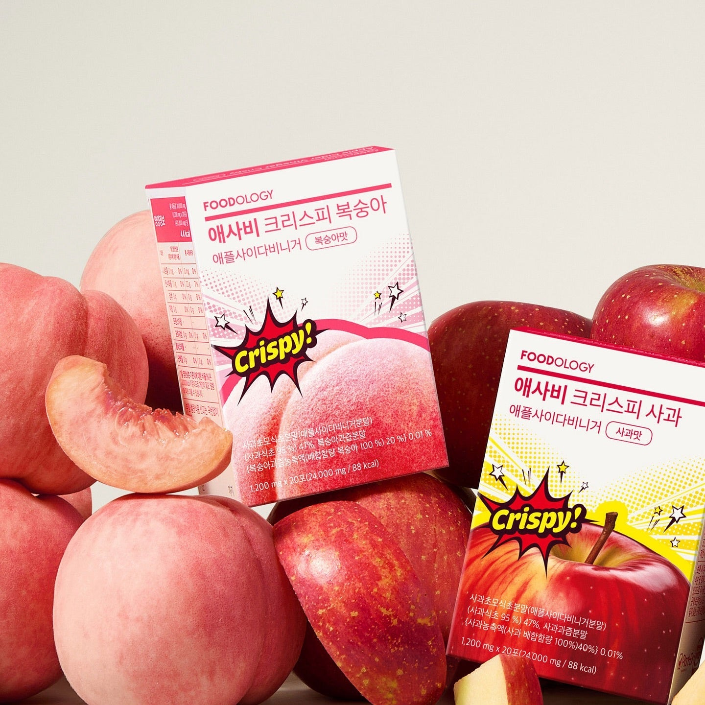 Boxes of FOODOLOGY Asabi Crispy 3 Types with fresh peaches and apples in the background.