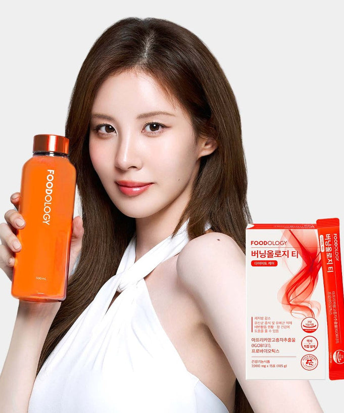 Woman holding FOODOLOGY Burningology tea (x15) with product packaging displayed.