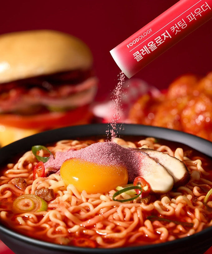 FOODOLOGY Cutting Powder being sprinkled on ramen bowl with burger and chicken on the side.