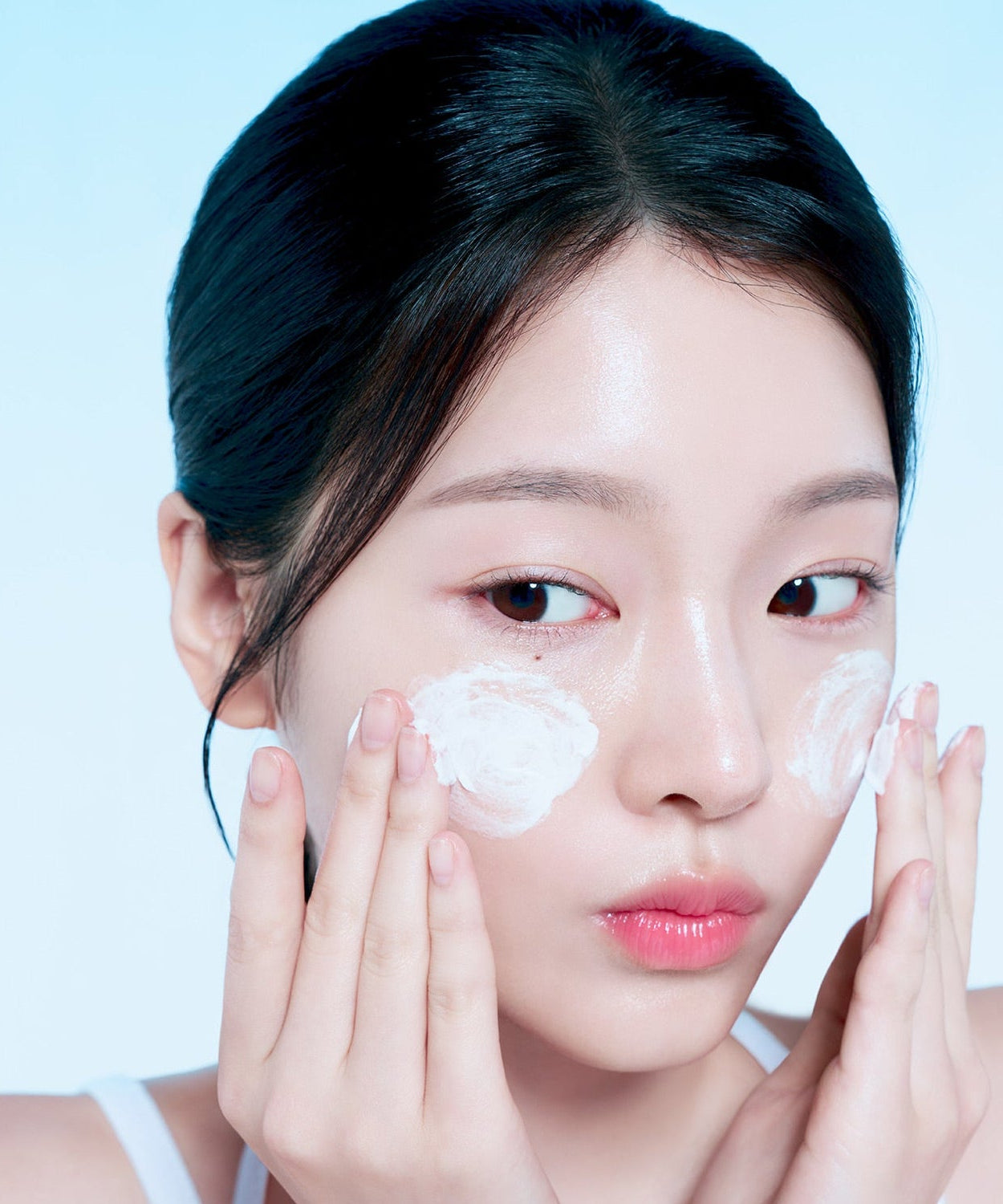 Woman applying FORENCOS Plum C Mild Mild Acidic Cleansing Foam 150g on cheeks