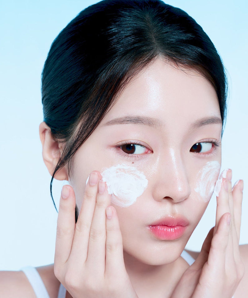 Woman applying FORENCOS Plum C Mild Mild Acidic Cleansing Foam 150g on cheeks