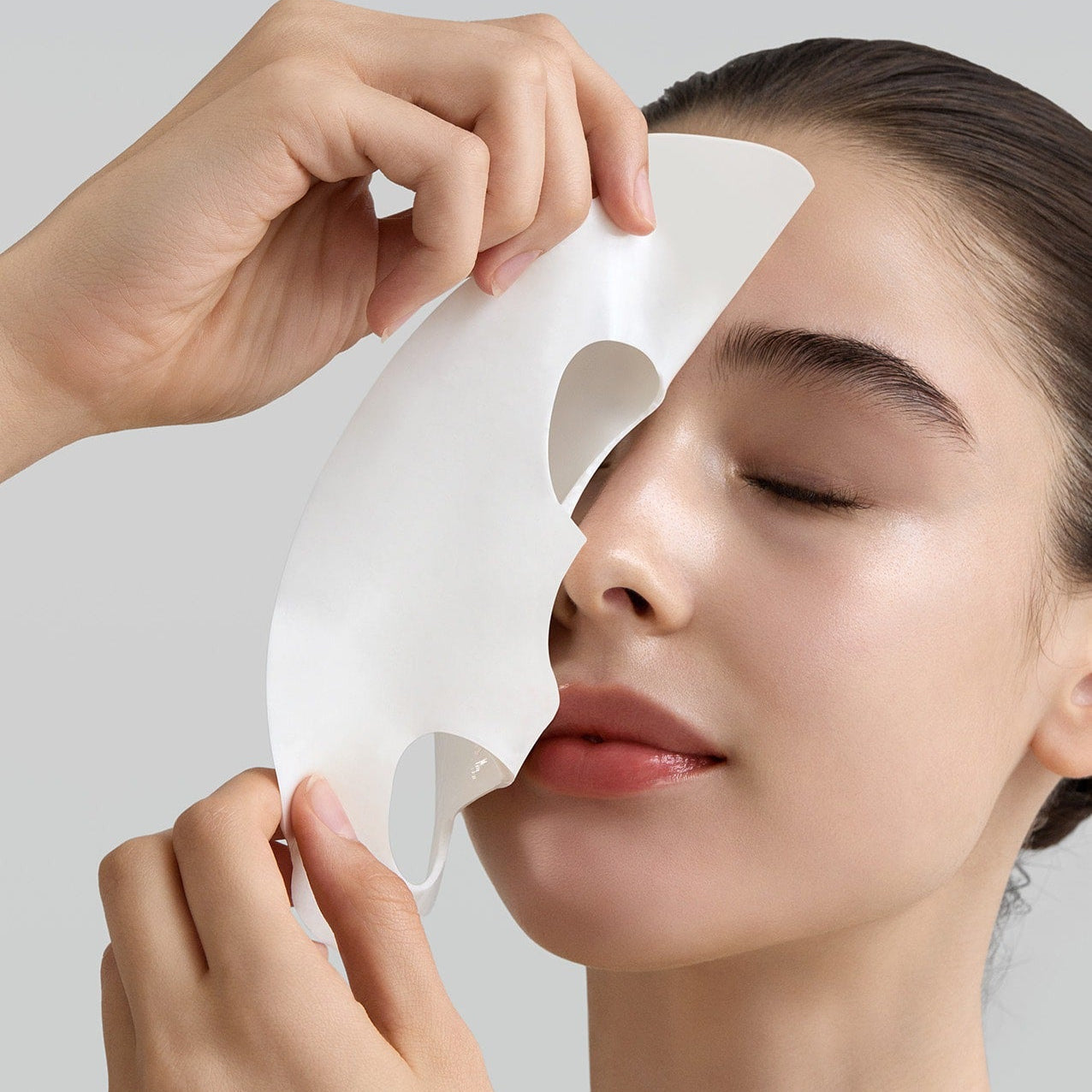 Person applying FULLY Rice dough modeling mask 4ea to face, showcasing skincare benefits and texture.