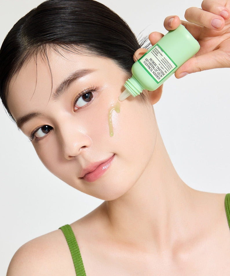 Woman applying FULLY Green Tomato Acid 20 Wash-Off Peeling Serum 50ml on her cheek for skincare routine.