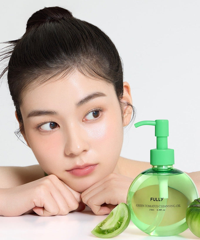 Woman with FULLY Green Tomato Cleansing Oil 250ml bottle and green tomato slice in a skincare setting