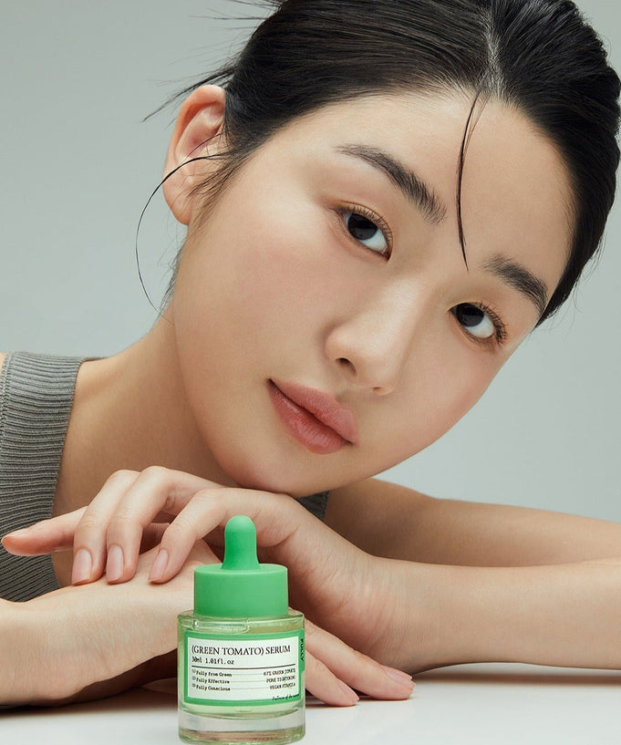 Woman with FULLY Green Tomato Serum 30ml in front of her, showcasing beauty skincare product.