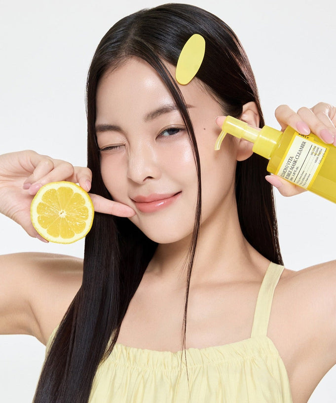 Woman holding FULLY Lemon Vita Bubble Pack Cleanser 150ml and a lemon slice, showcasing skincare product.