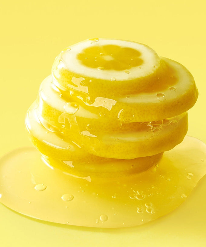 Stacked lemon slices on yellow background representing the citrus freshness of FULLY Lemon Vita Bubble Pack Cleanser 150ml.
