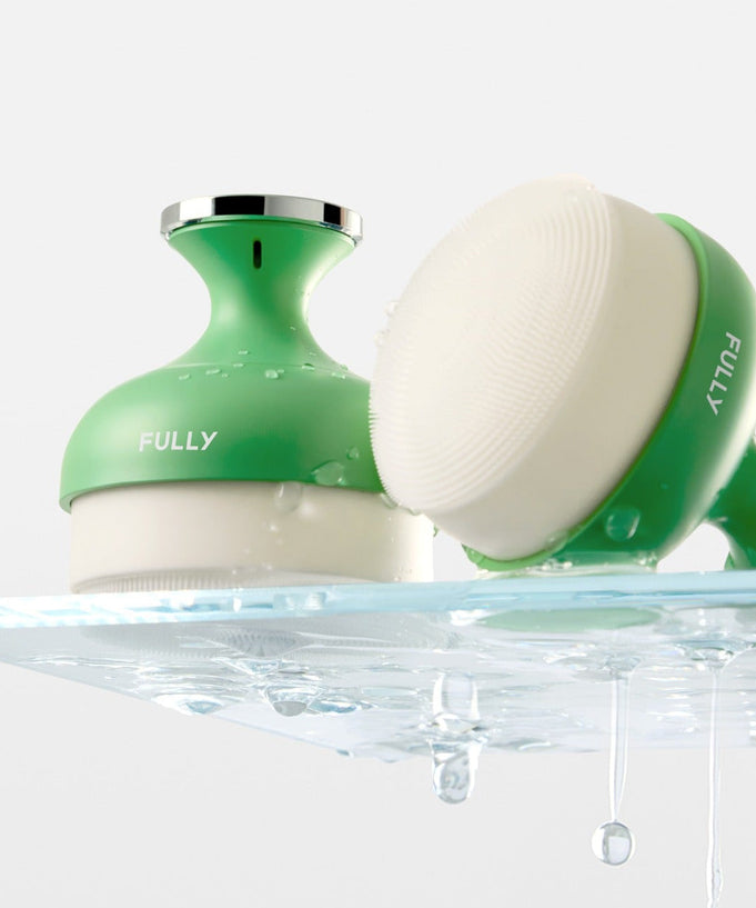 FULLY Pore brush resting on a wet surface, showcasing its compact design and bristle texture.