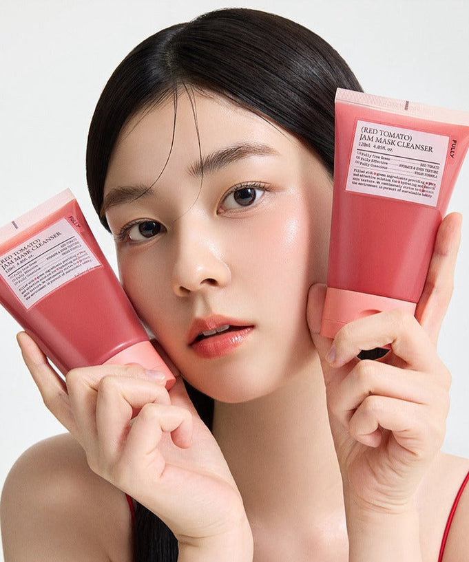 Woman holding two tubes of FULLY Red Tomato Jam Pack Cleanser 120ml with fresh complexion.