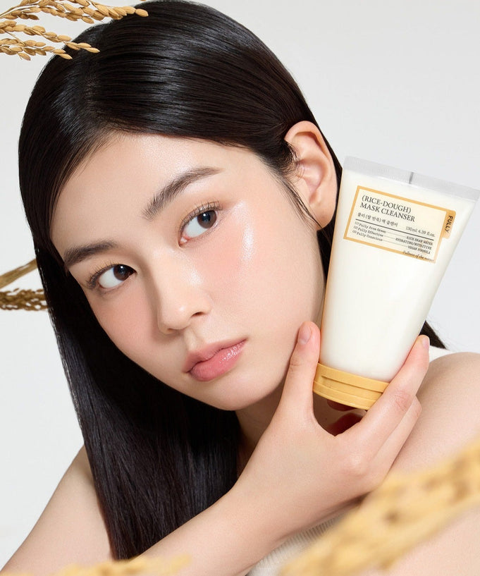 Woman holding FULLY Rice Dough Pack Cleanser 130ml bottle
