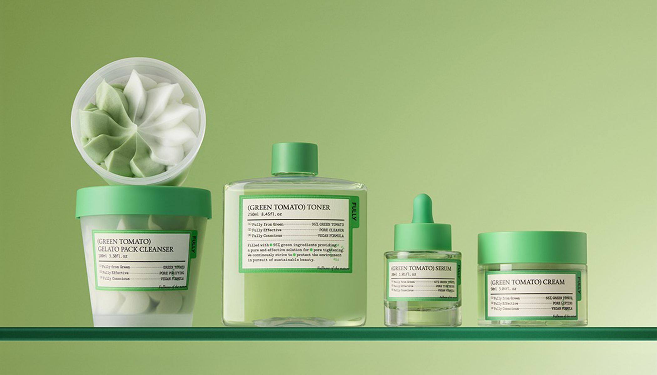 Green tomato skincare products including toner, cleanser, serum, and cream on a green background, promoting natural skincare essentials.