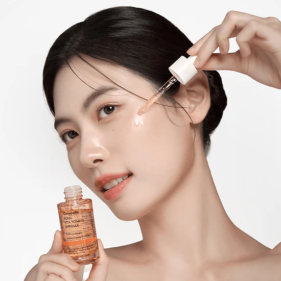 Woman applying GENABELLE PDRN Vita Toning Ampoule 30ml to her skin with dropper