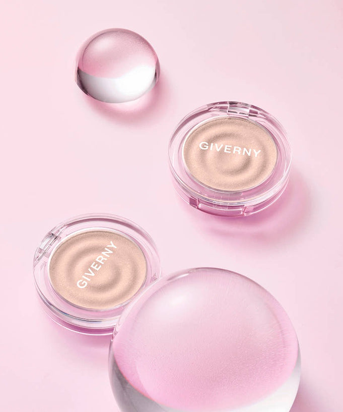 GIVERNY Dewy Voluming Highlighter 3g in packaging with pink background, showcasing the product's sleek design and voluminous effect