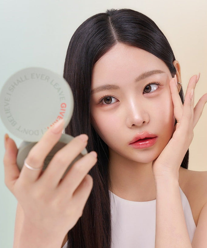 Woman applying makeup using the GIVERNY Milkchak Cover Cushion 12g.