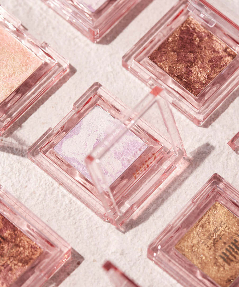 GLINT Glint Highlighter (Marble) in a stylish compact case on display among various shades.