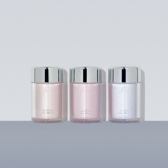 Three containers of GLOW Seasoning Highlighter in different shades on a gray surface.