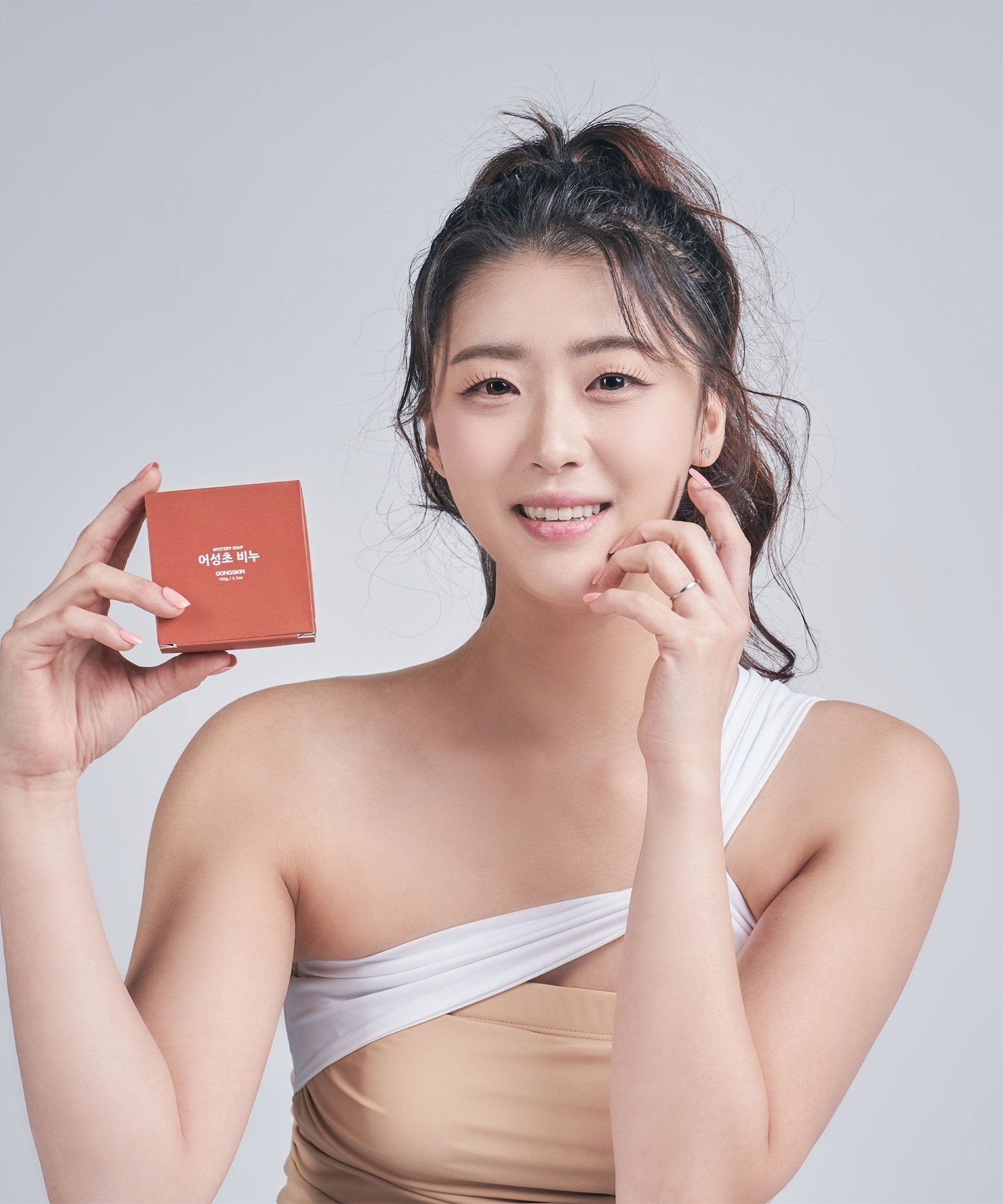 Person holding GONGSKIN Eoseongcho Soap 100g box, showcasing the product.