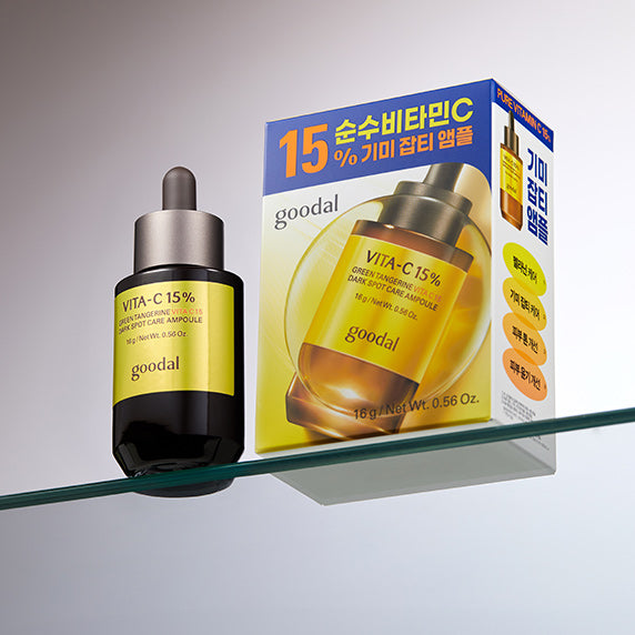 GOODAL Green Tangerine Vita C 15 Spot Care Ampoule 16g bottle and packaging on a glass shelf.