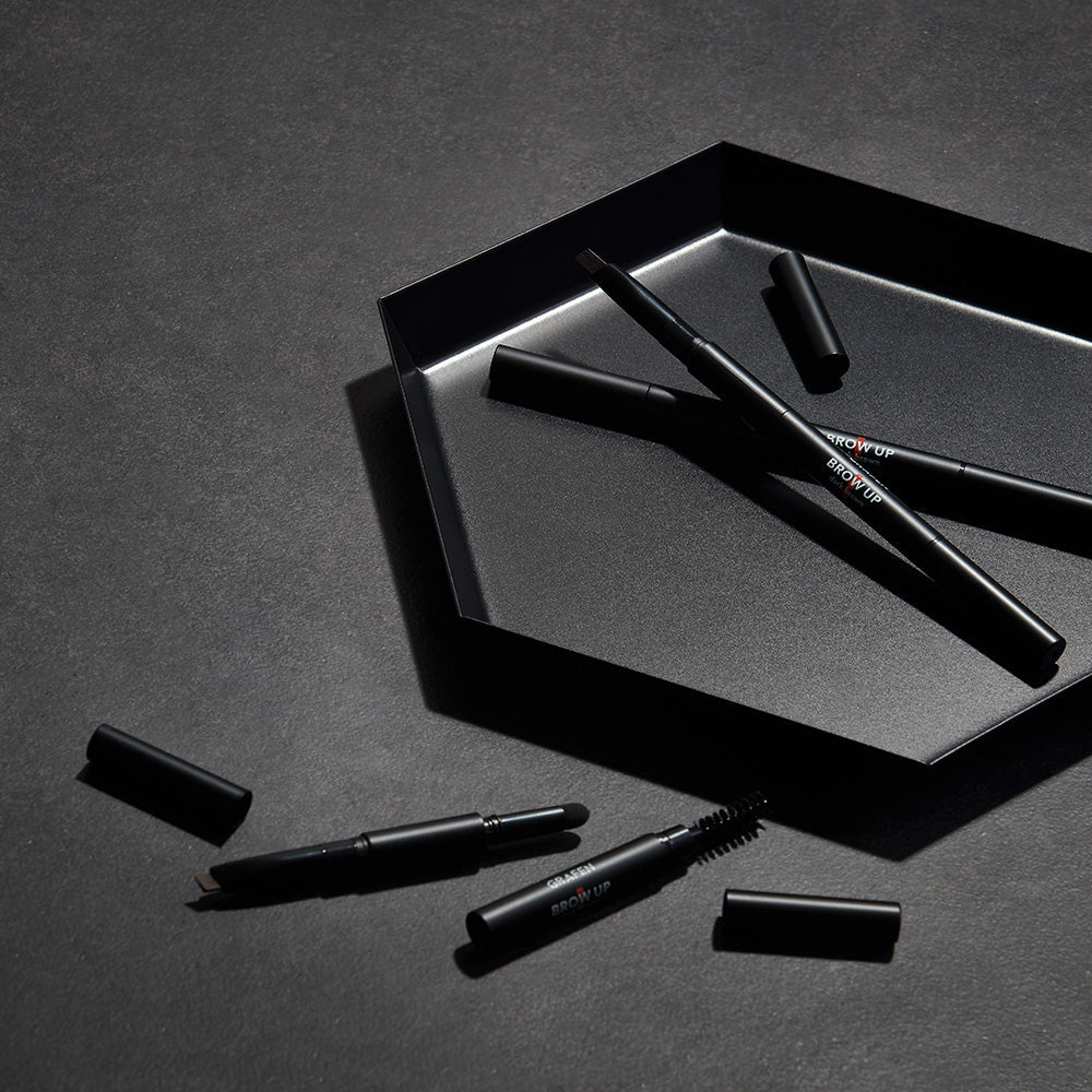 GRAFEN Brow Up Brow Pencil 0.3g displayed on dark tray with caps off, Gentleman Korea men's eyebrow pencil for natural grooming