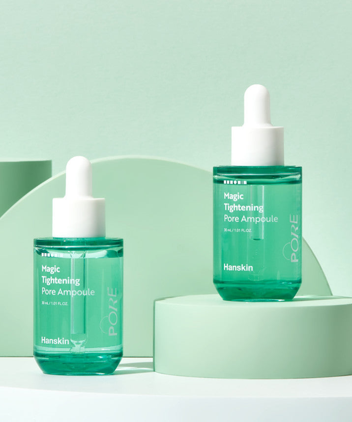HANSKIN Magic Tightening Pore Ampoule 30ml displayed on elegant green background showing skincare product design with dropper.