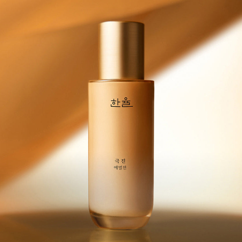 HANYUL Extreme Emulsion 125ml bottle with golden cap and Korean branding on a warm gradient background.
