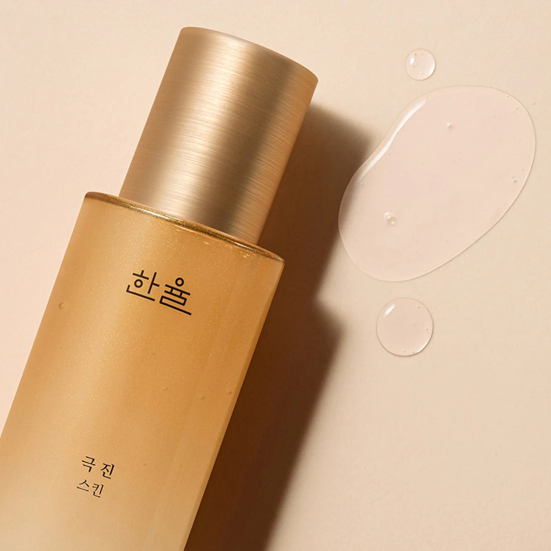 HANYUL Extreme Skin 125ml bottle on beige background with droplets