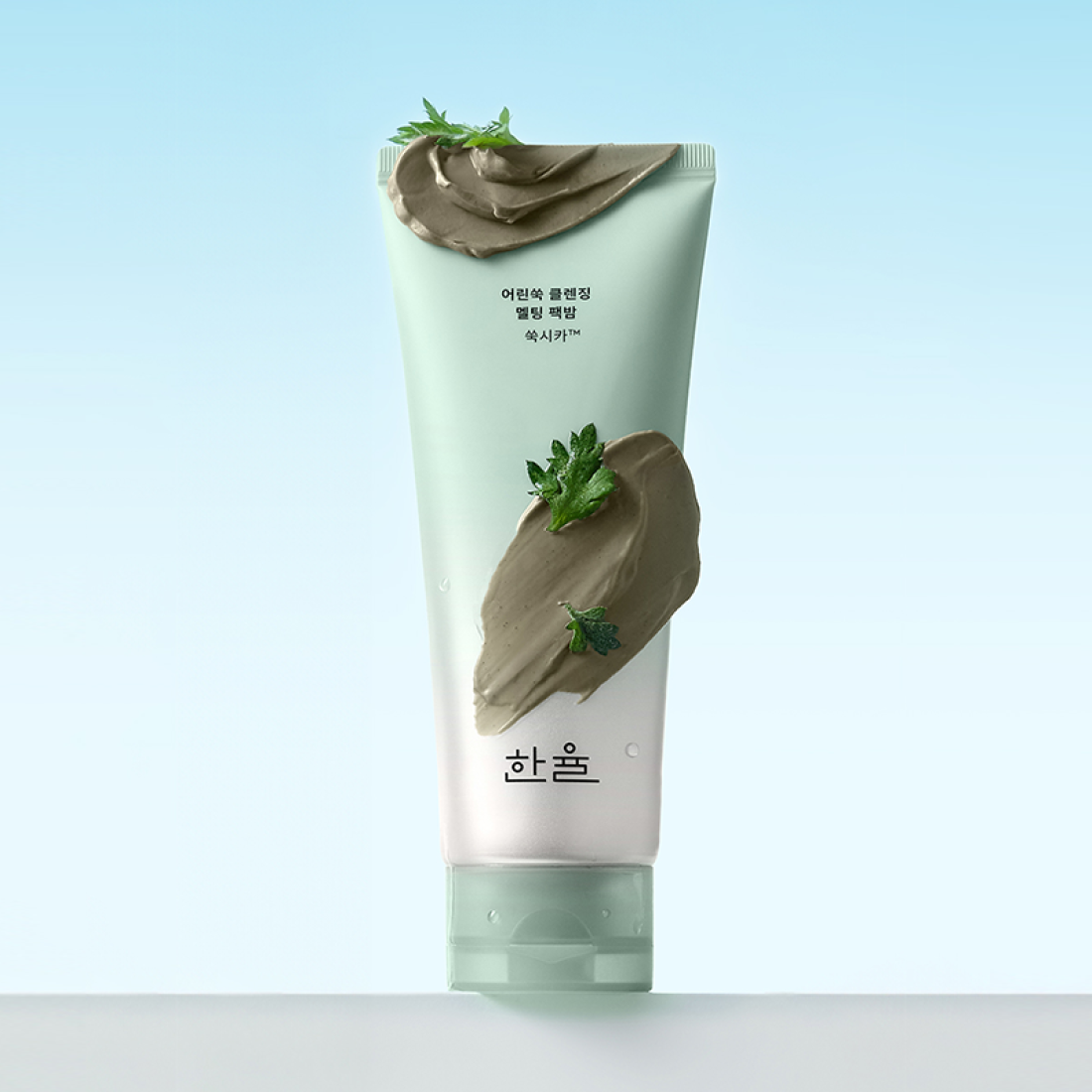 HANYUL Young Artemisia Cleansing Pack Balm 100g front view with texture and natural ingredients on light blue background.